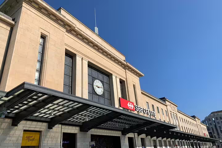 Geneva Cornavin train station facade with SBB CFF FFS sign and clock on sunny day