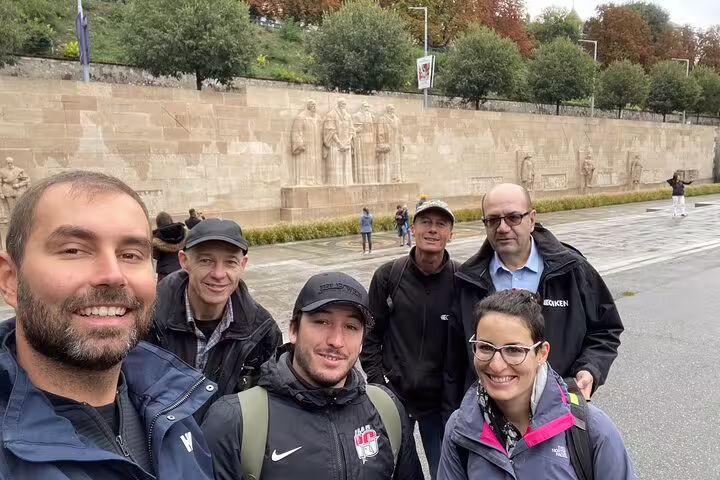 Group selfie by Geneva Reformation Wall on an interactive scavenger hunt and city highlights walking activity