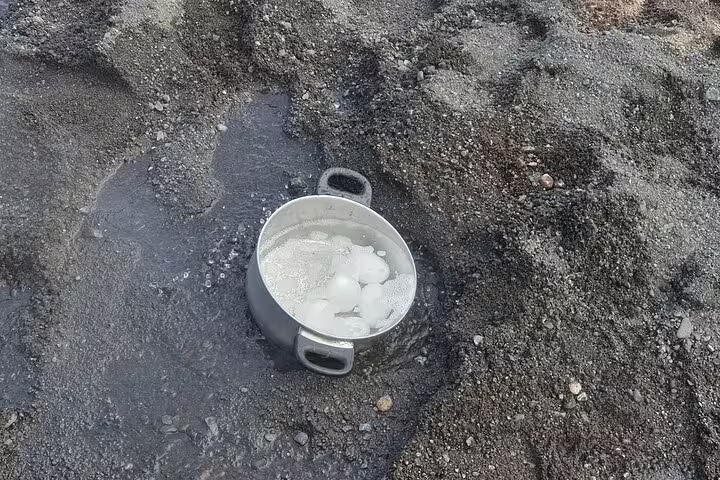 Eggs boiling in a pot submerged in a geothermal hot spring on Iceland's Golden Circle