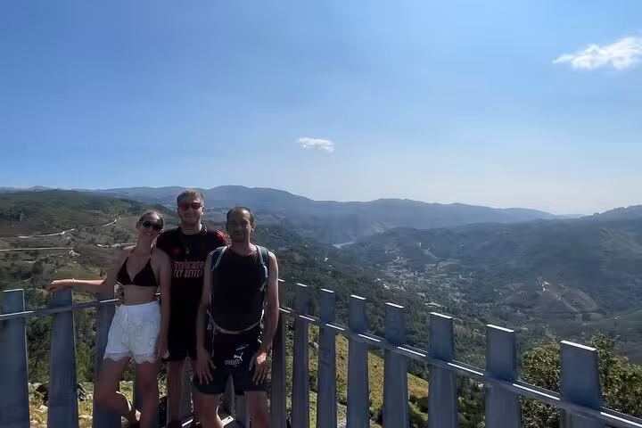 Group of hikers at a scenic viewpoint overlooking expansive mountain landscapes in Geres National Park.