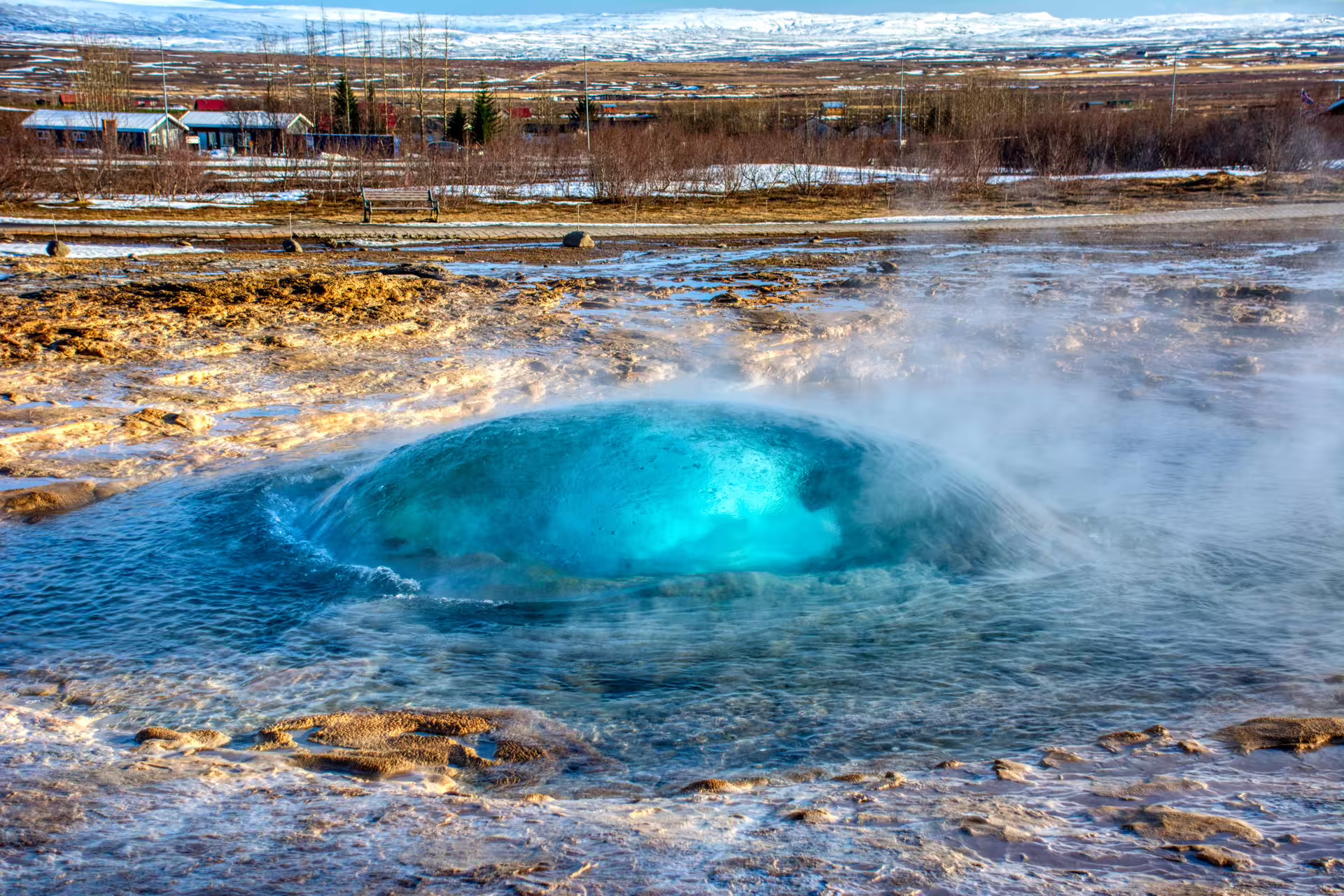 Geyser eruption in Iceland's Golden Circle with vibrant blue water, part of a scenic adventure tour with Friðheimar feast.