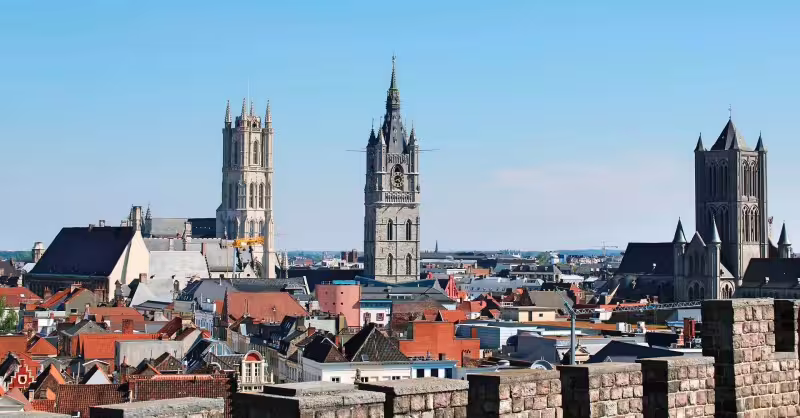 Panoramic view of Ghent's historic skyline featuring medieval towers and vibrant rooftops, ideal for a private walking tour.