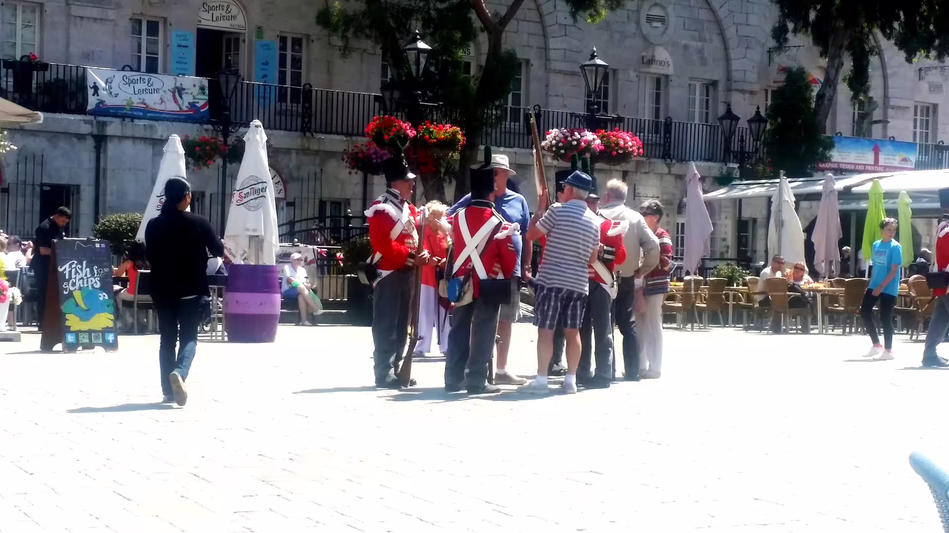 British redcoat soldiers and tourists in Casemates Square Gibraltar, seen on private tour from Costa del Sol