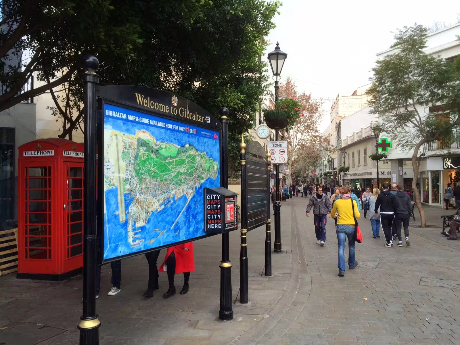 Welcome to Gibraltar map sign and red phone booths on Main Street, a stop on private tour from Costa del Sol