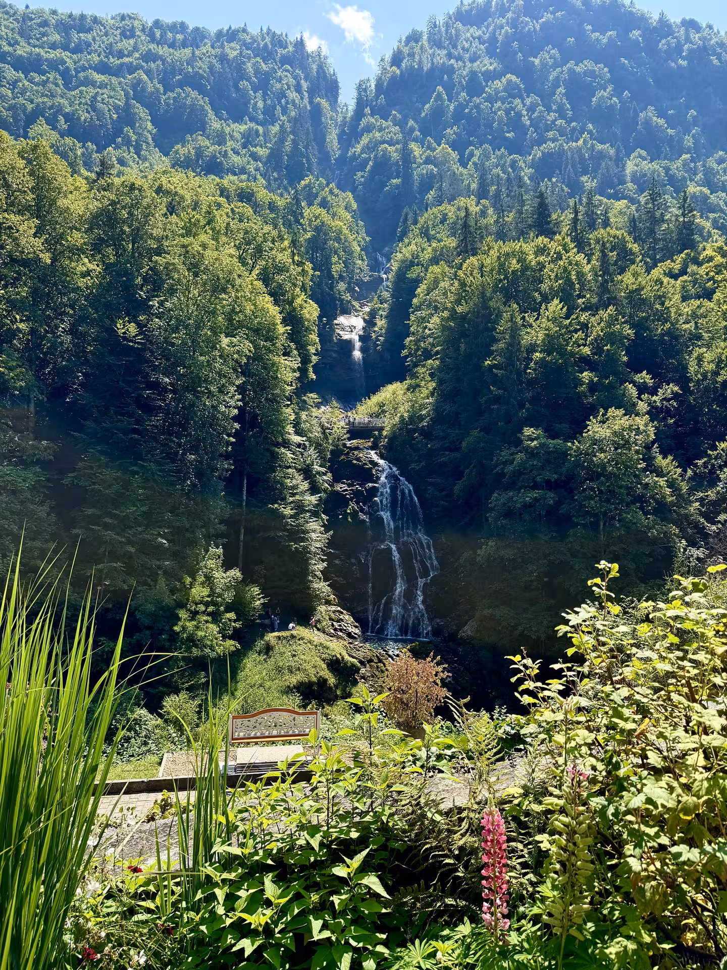 Giessbach Falls cascading through Swiss forest above Lake Brienz, highlight of Iseltwald & Giessbach e-bike tour