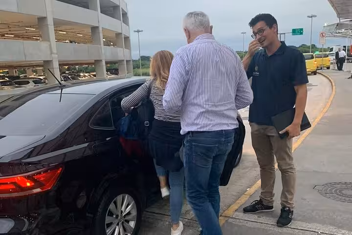 Passengers entering a private shuttle car at GIG Airport, ensuring smooth transfers to hotels in Rio's South area.
