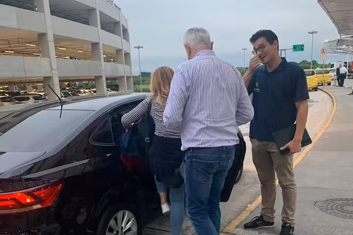 Passengers boarding a private transfer vehicle at GIG Airport for a seamless journey to Barra da Tijuca hotels.
