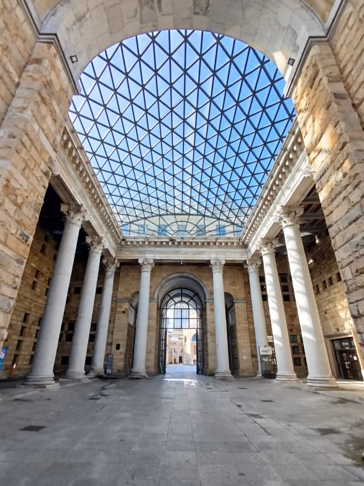 Interior view of the University of Laboral in Gijon showcasing its impressive architecture and glass dome ceiling.