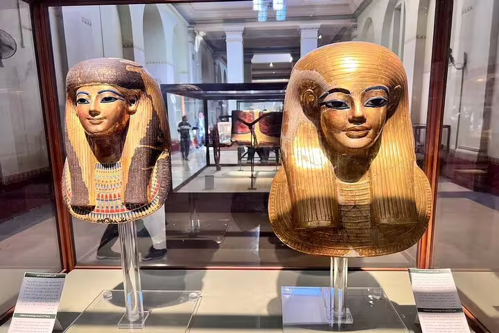 Close-up of gilded ancient Egyptian masks at Cairo Museum on Pyramids of Giza day tour by bus from Sharm