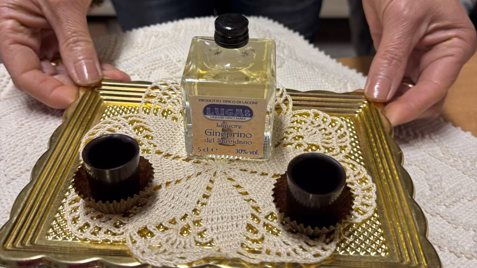 Ginger liqueur bottle with dark chocolate cups on an elegant tray for Laconi tasting tour.