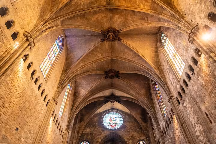 Intricate vaulted ceilings and stained glass windows inside a historic Girona cathedral on a guided city tour.