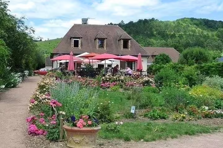 Flower-filled garden terrace near Giverny on a private tour from Paris, Normandy countryside stop
