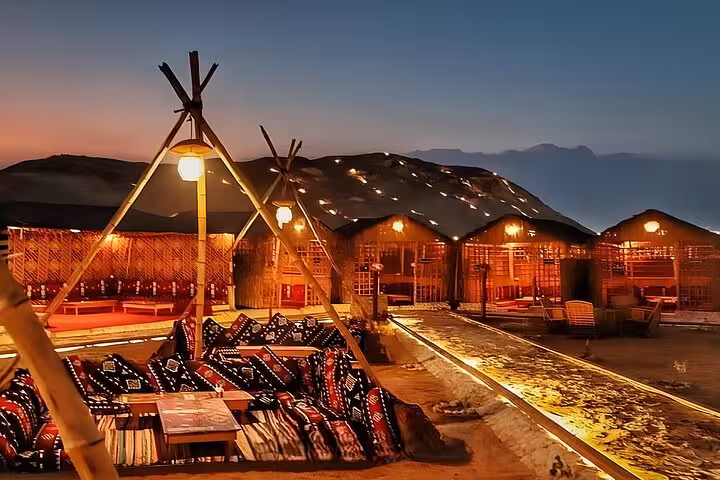 Sunset at Giza Bedouin village with lanterns and lounge seating for VIP Arabian Night dinner show and photos
