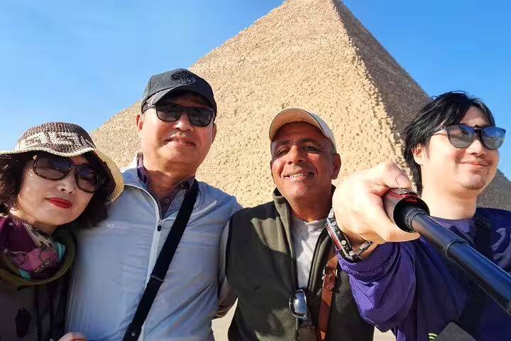 Group selfie with local guide at Giza Pyramid, part of Memphis and Saqqara pyramids day trip from Cairo