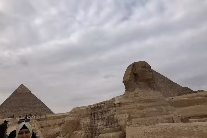 Great Sphinx and Giza Pyramid under cloudy sky, must-see stop on private Cairo pyramids day trip