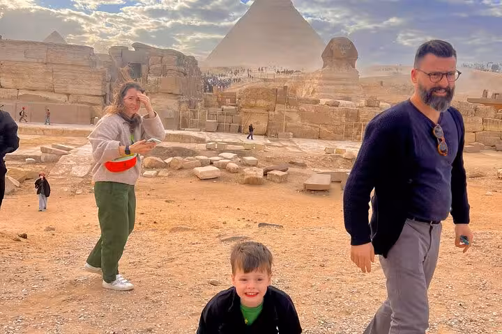 Family visiting the Great Sphinx and Giza Pyramid plateau on a private Cairo tour with Citadel, bazaar and Nile felucca