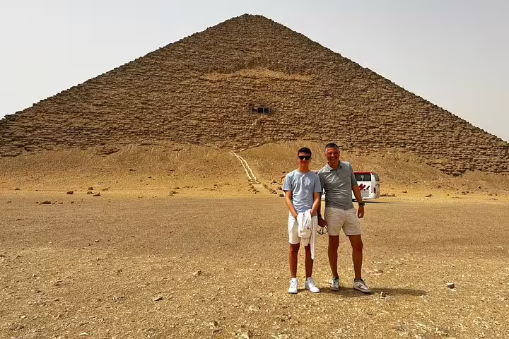 Travelers posing by the Great Pyramid of Giza on Alexandria Port day tour with cruise and lunch