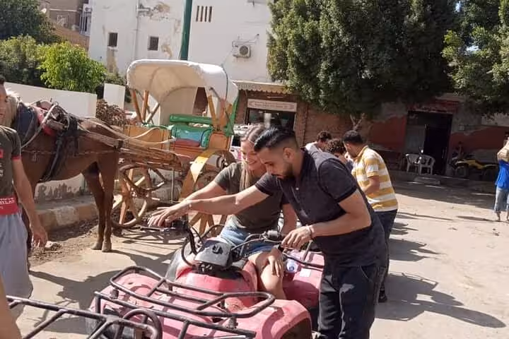 Tourists preparing an ATV quad bike in Giza village, part of private Giza Pyramids adventure tour