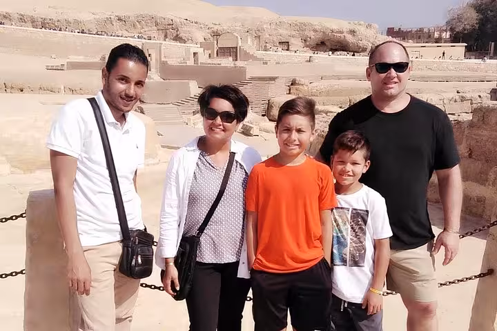 Travelers with local guide at Giza Plateau near the pyramids, Cairo day trip stop on Egypt highlights tour