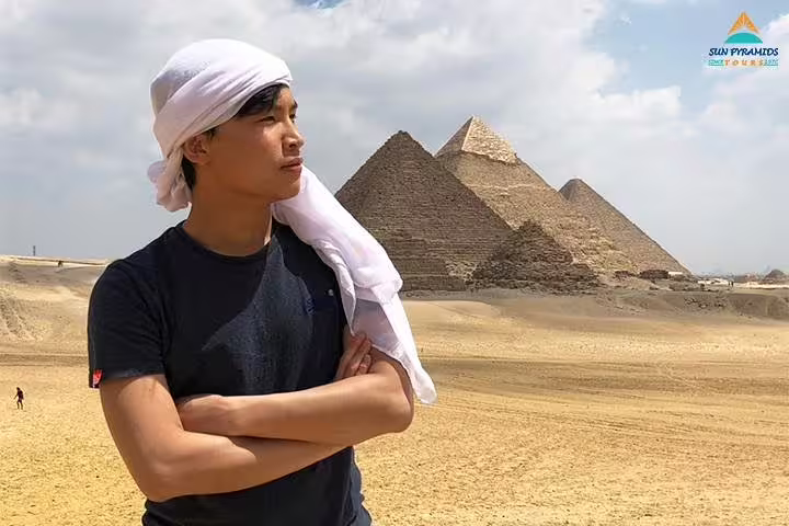 Tourist at the Giza Pyramids in Cairo desert, highlight of the 4-day Cairo and Red Sea tour package in Egypt