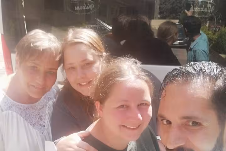 Happy travelers with private Egypt guide during full-day Cairo tour to Giza Pyramids, Museum, felucca and camel