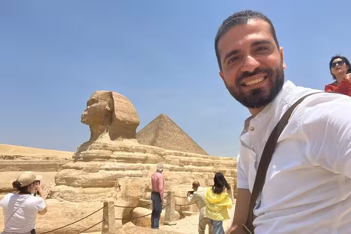 Traveler selfie by the Great Sphinx and Giza Pyramid on private Giza tour with camel ride, ATV option and cruise