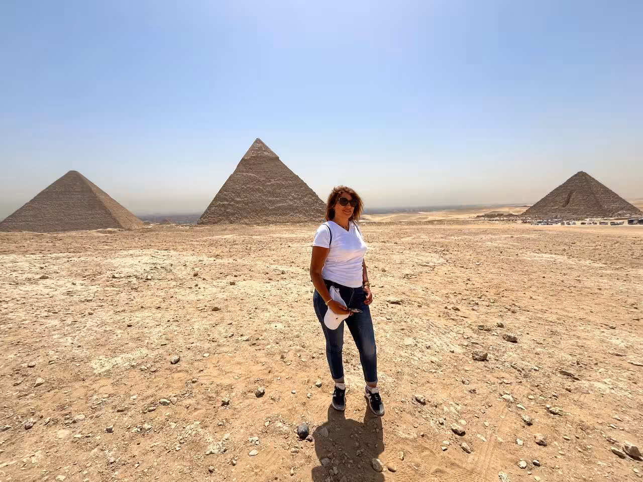 Traveler posing near the Great Pyramids of Giza, Cairo during camel ride and lunch tour with panoramic views