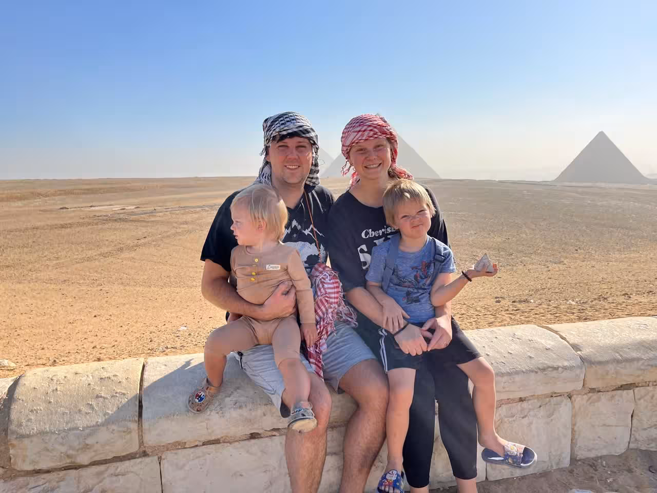 Family photo at Giza Pyramids viewpoint, Cairo camel ride and lunch tour with panoramic desert scenery