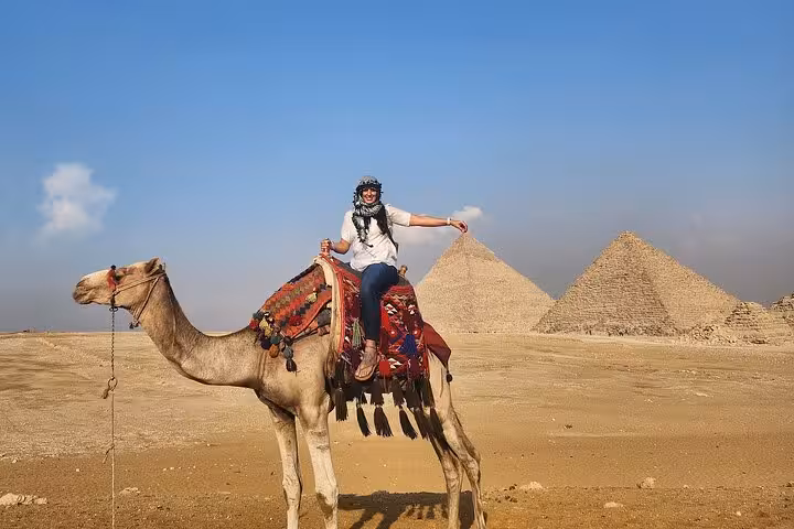 Rider on camel at Giza Plateau facing pyramids, VIP camel ride experience with free photographer photoshoot