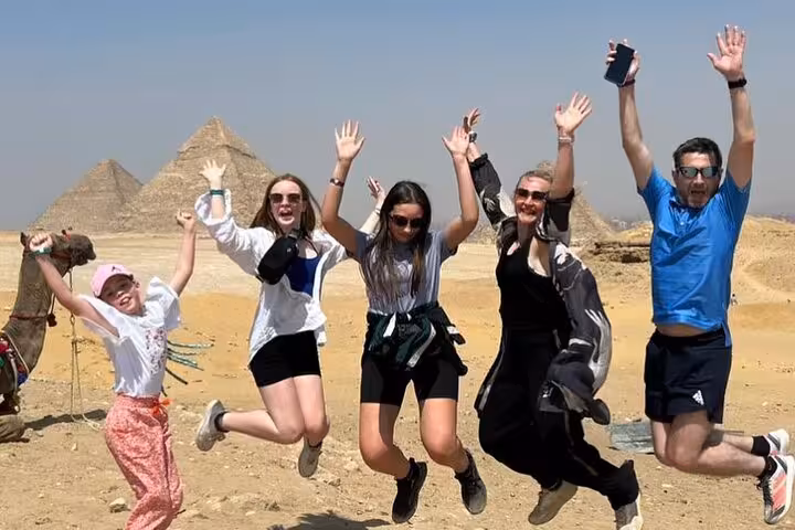 Group photo jumping at Giza Pyramids during private trip with quad bikes, camel rides, lunch included and tickets