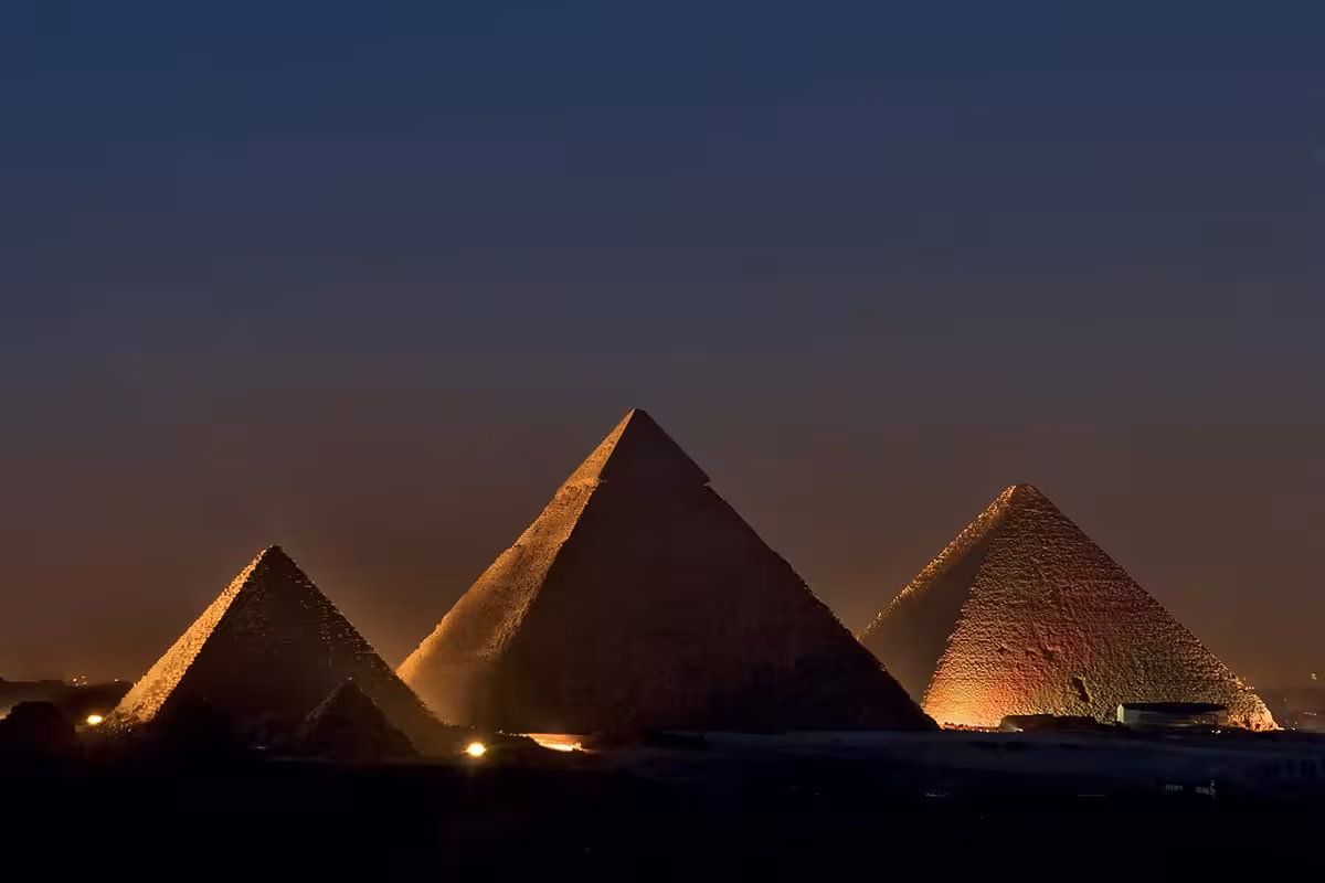 Giza pyramids illuminated at night for the Sound and Light Show, unforgettable evening tour in Cairo