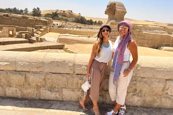 Travelers posing by the Great Sphinx on a private Giza Pyramids tour, ideal for camel ride and quad biking