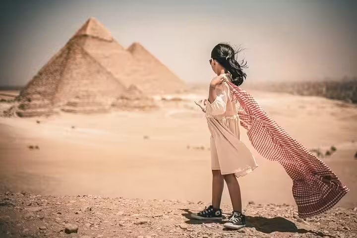 Traveler overlooking the Pyramids of Giza on VIP Giza Plateau experience, scenic photo session with free photographer