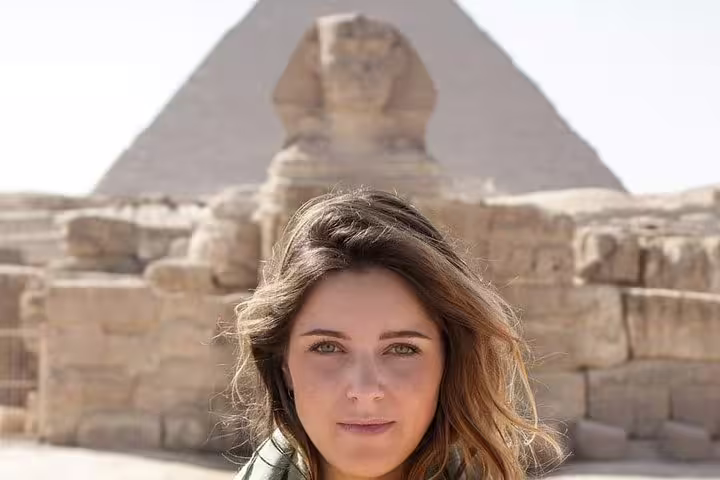Traveler at the Great Sphinx with Giza Pyramid backdrop on private guided tour with transfers and tickets