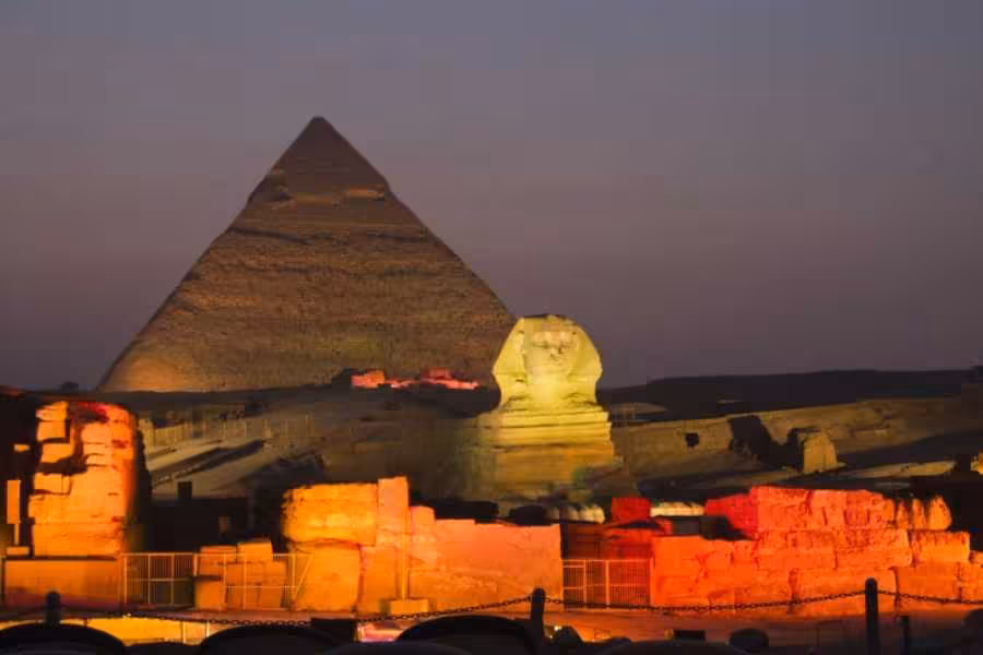 Sphinx and Great Pyramid at dusk lit for the Giza Pyramids Sound and Light Show, Cairo night sightseeing tour