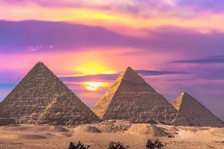 Giza Pyramids at sunset in Cairo desert, iconic view on private guided tour with hotel transfers and tickets
