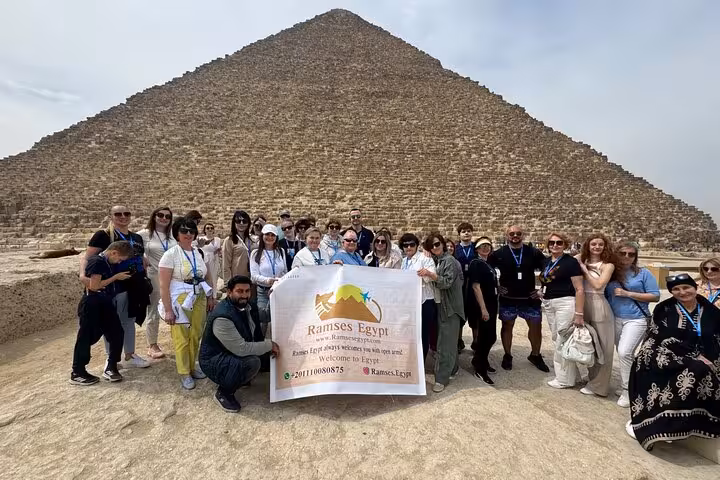 Private Giza Pyramids tour group photo at the Great Pyramid with guide, Cairo day trip experience