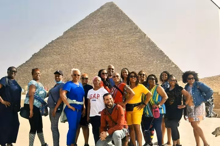 Group photo at the Great Pyramid of Giza on a private guided pyramids and Sphinx tour with lunch included