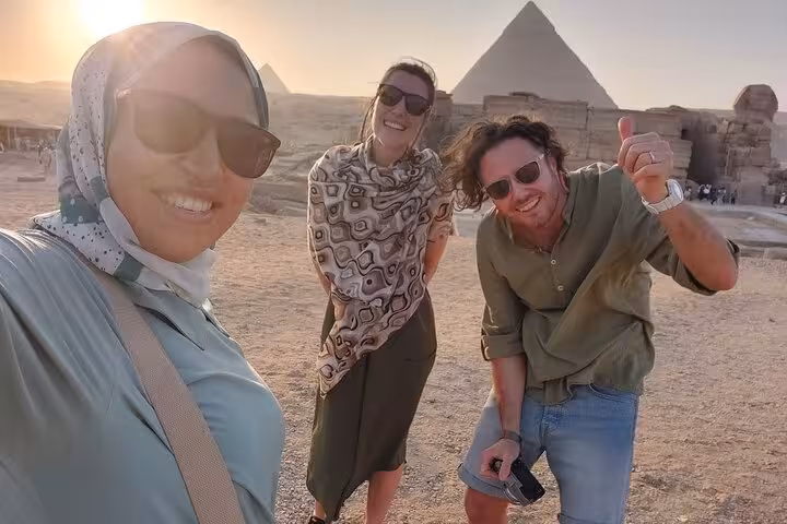 Sunset group photo at Giza Pyramids on a private tour with Egyptian Museum visit, felucca cruise and camel ride