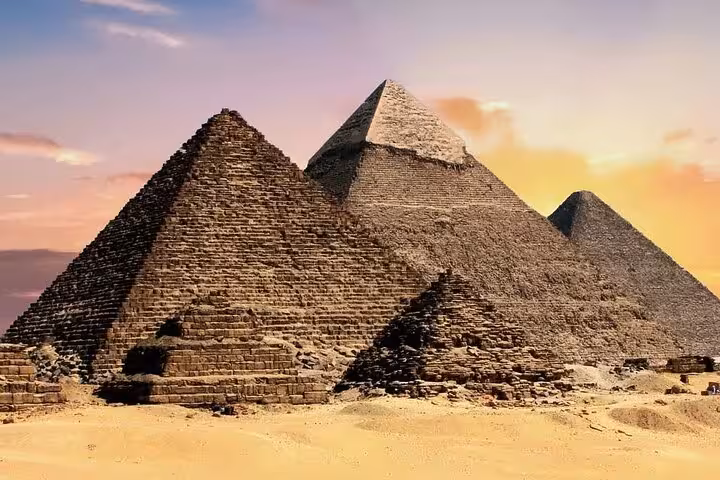 Sunset view of the Giza Pyramids, highlight of the fly from Sharm El Sheikh to Cairo pyramids tour