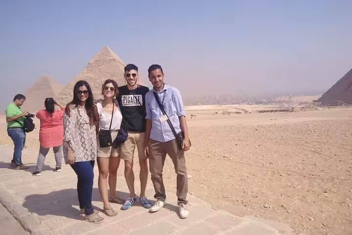 Tour group photo at Giza Pyramids with local guide on private full-day trip including Egyptian Museum and felucca