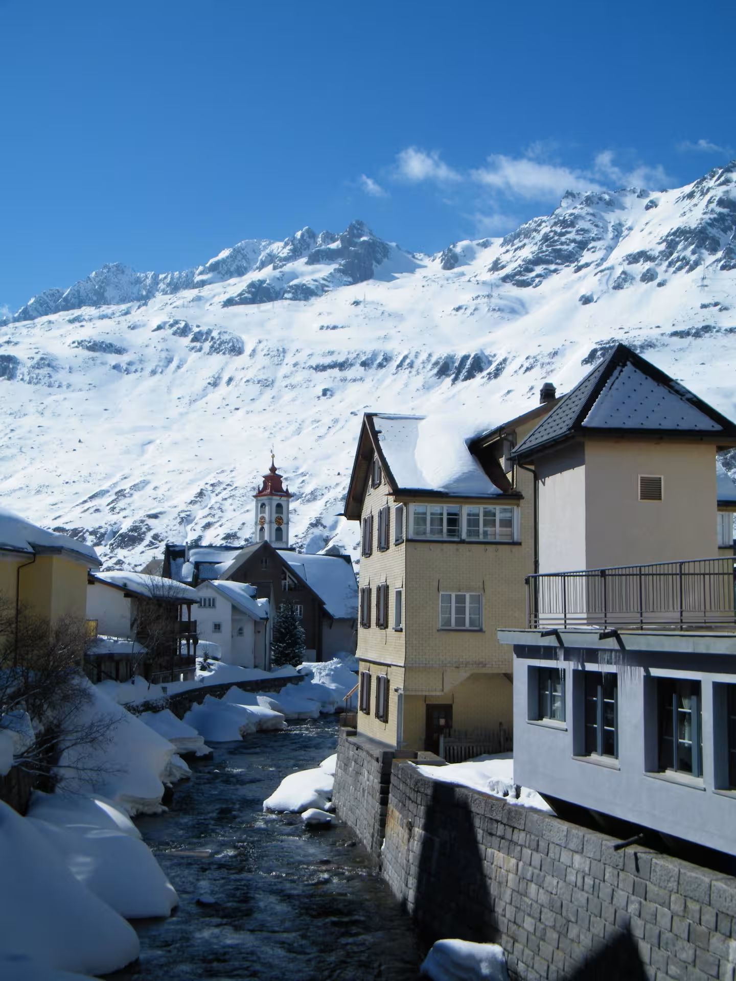 Snowy Swiss alpine village by a river, classic stop on the Glacier Express route private tour from Zurich