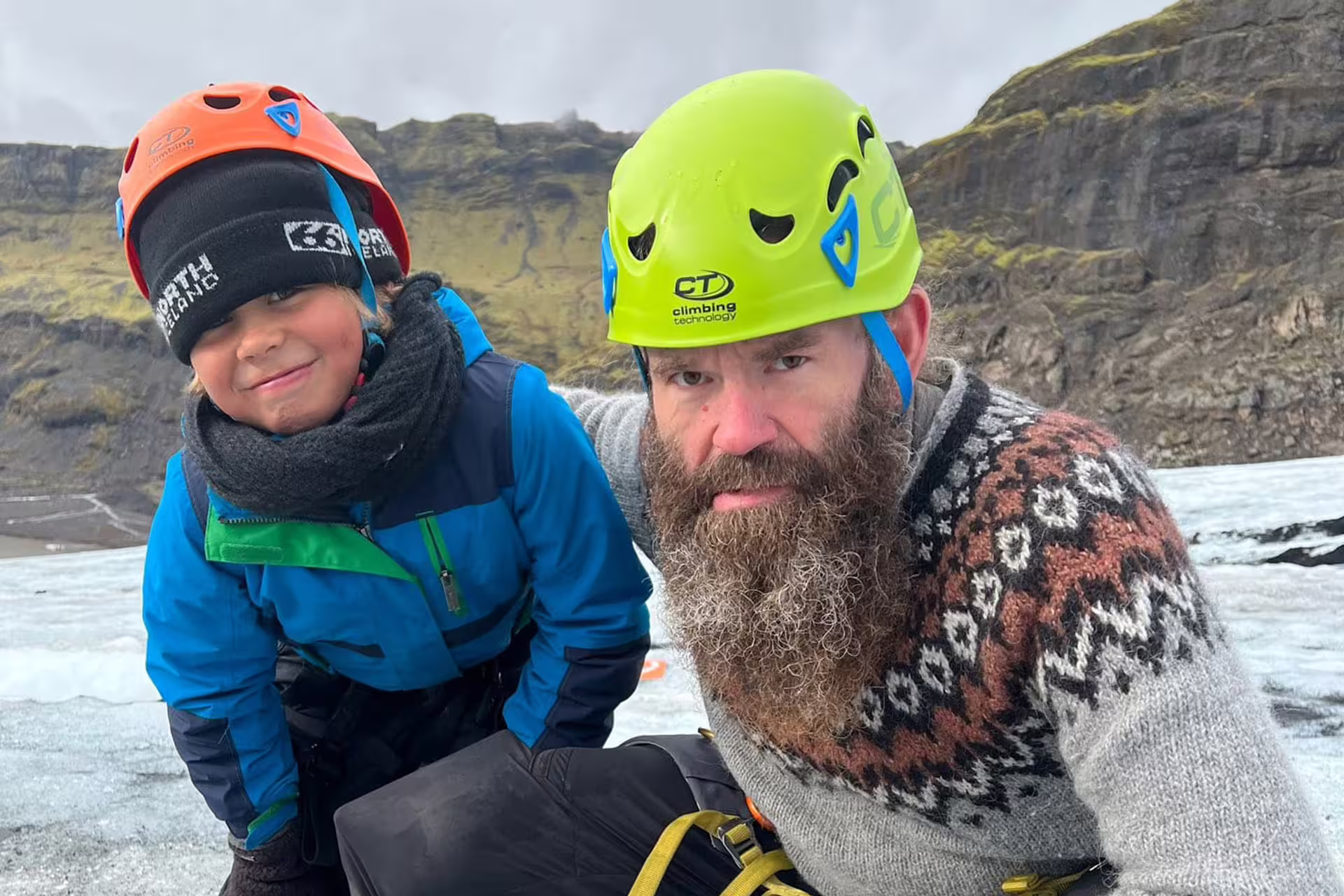 The glacier guide and a boy are making a "Viking face" on the glacier.