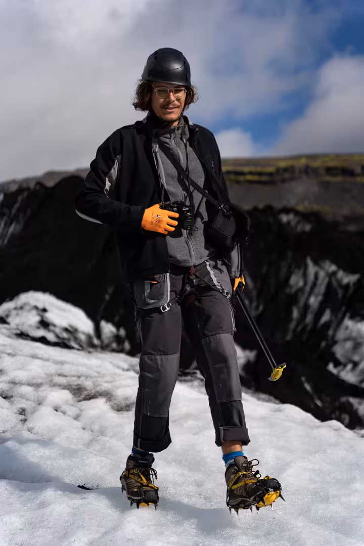 Guide wearing crampons and helmet standing on Solheimajokull glacier in Iceland