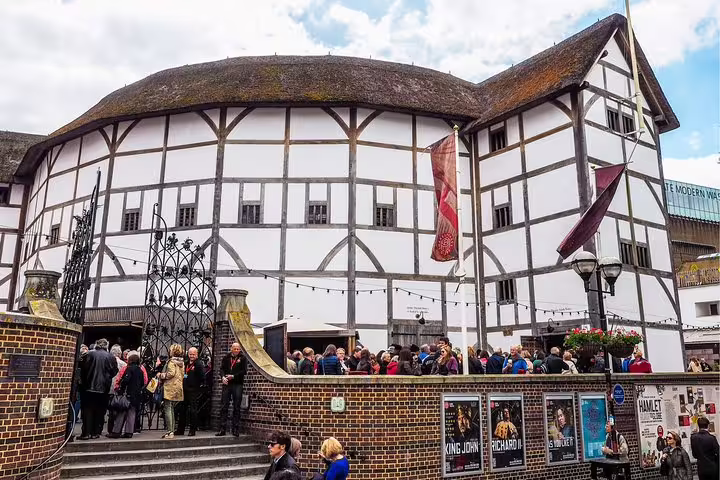 Visitors gather outside the iconic Shakespeare's Globe Theatre, a highlight of the Private Skip-the-Line Tower of London Tour.