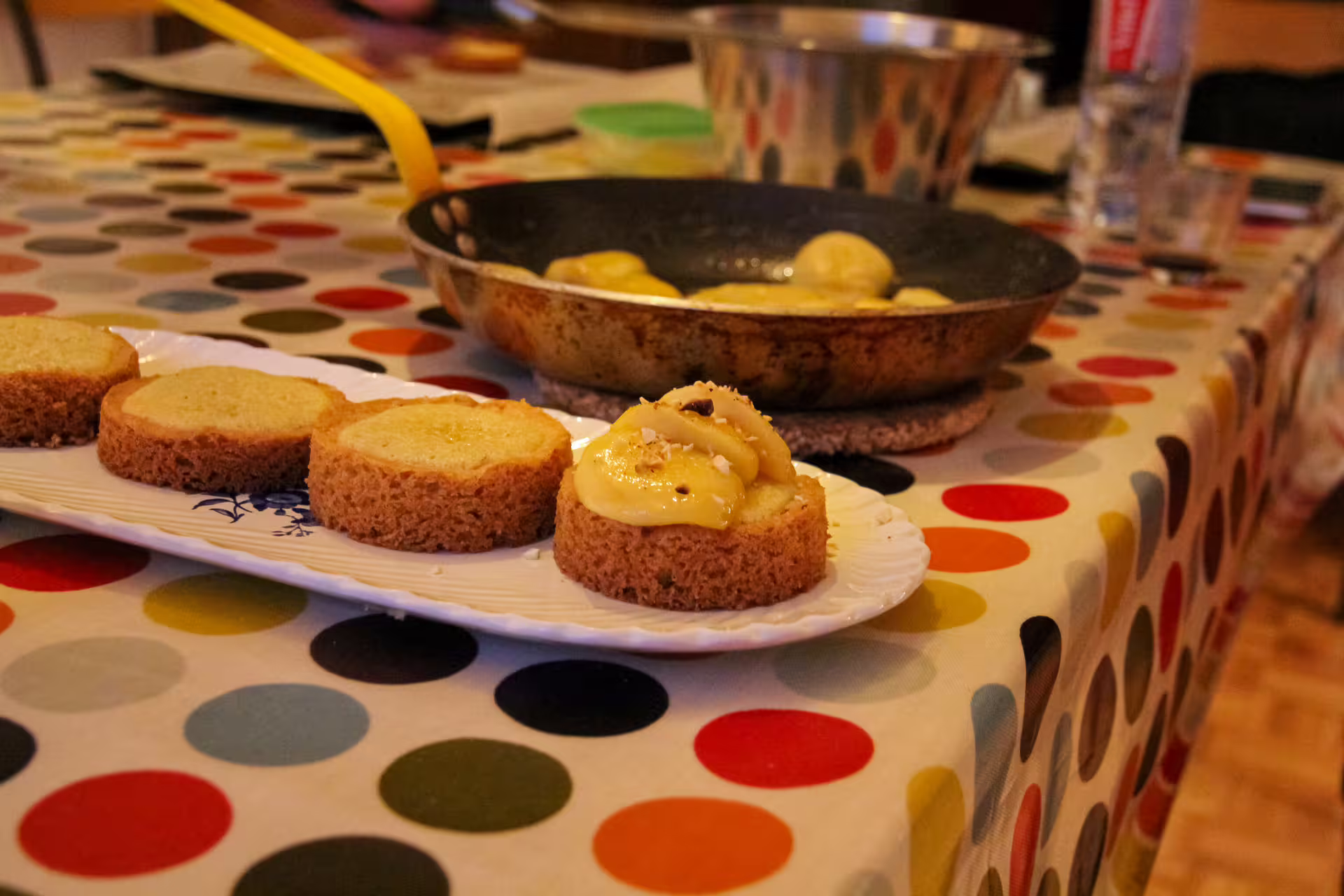 Gluten-free cake slices topped with caramelized banana sauce on a white plate during Paris cooking class
