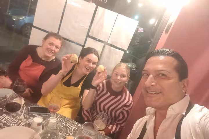 Group enjoying a gluten-free pasta course in Rome, showcasing their handmade pasta creations with joyful expressions.