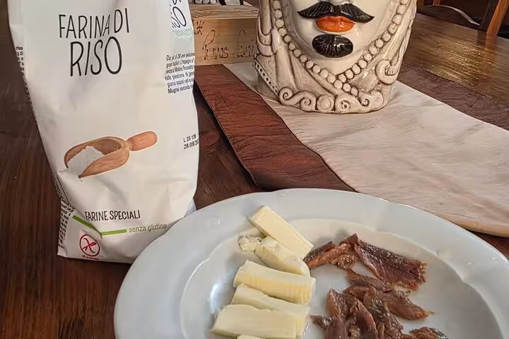 Gluten-free ingredients including rice flour, cheese, and anchovies used in Roman cooking class with Chef Christian.