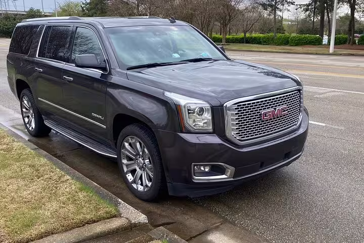 A sleek GMC Denali SUV ready for a premium private transfer from London to Stansted Airport STN.