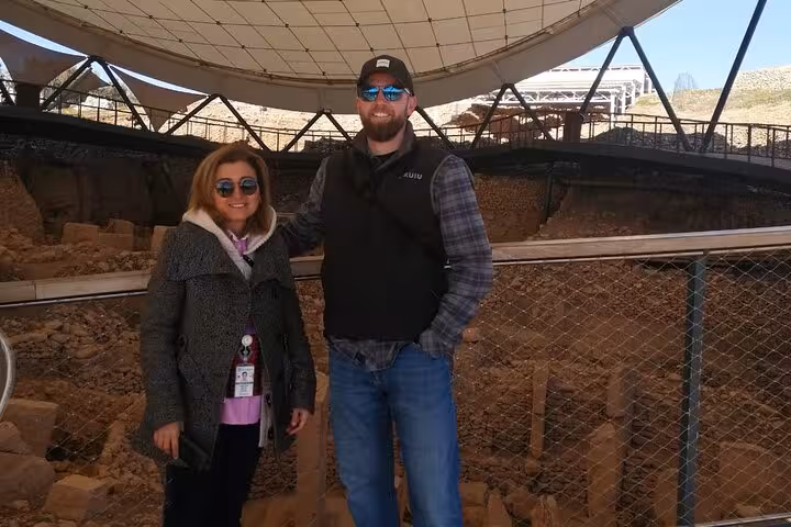 Tour guide and visitor posing at Göbeklitepe archaeological site near Şanlıurfa on Istanbul all-inclusive tour